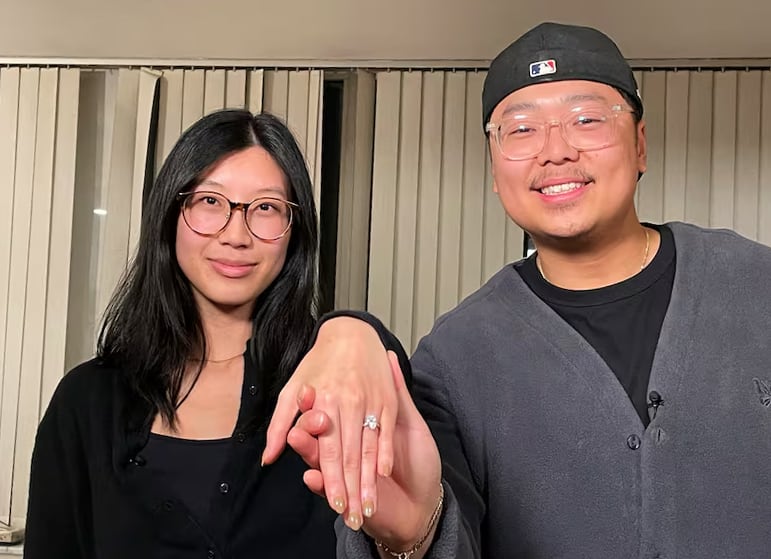 Olivia Chan shows the camera her the lab-grown diamond engagement ring, alongside fiancé Daniel Ng. 