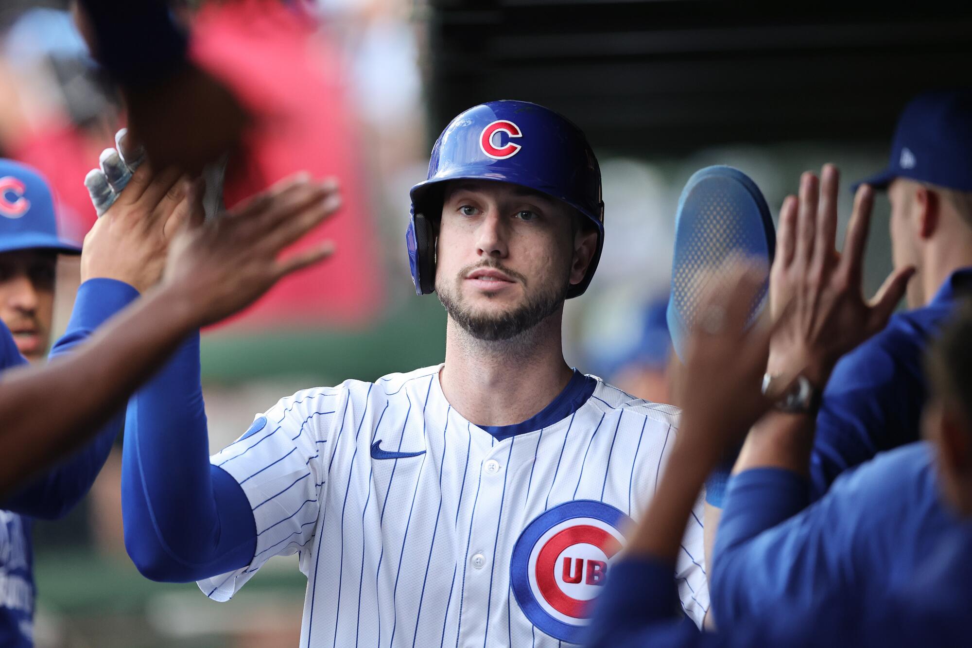 Kyle Tucker celebrates with his Chicago Cubs teammates after scoring a run against the San Diego Padres on Oct. 2.