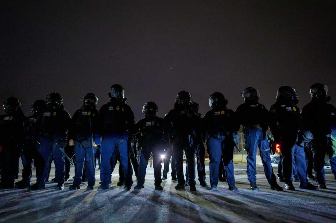 Federal immigration officers confront protesters outside Bishop Henry Whipple Federal Building, Jan. 15, 2026, in Minneapolis.
