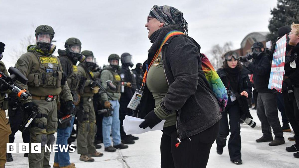 A protester (centre) shouts towards a line of federal law enforcement agents during an anti-ICE demonstration outside the Bishop Whipple Federal Building in Minneapolis, Minnesota