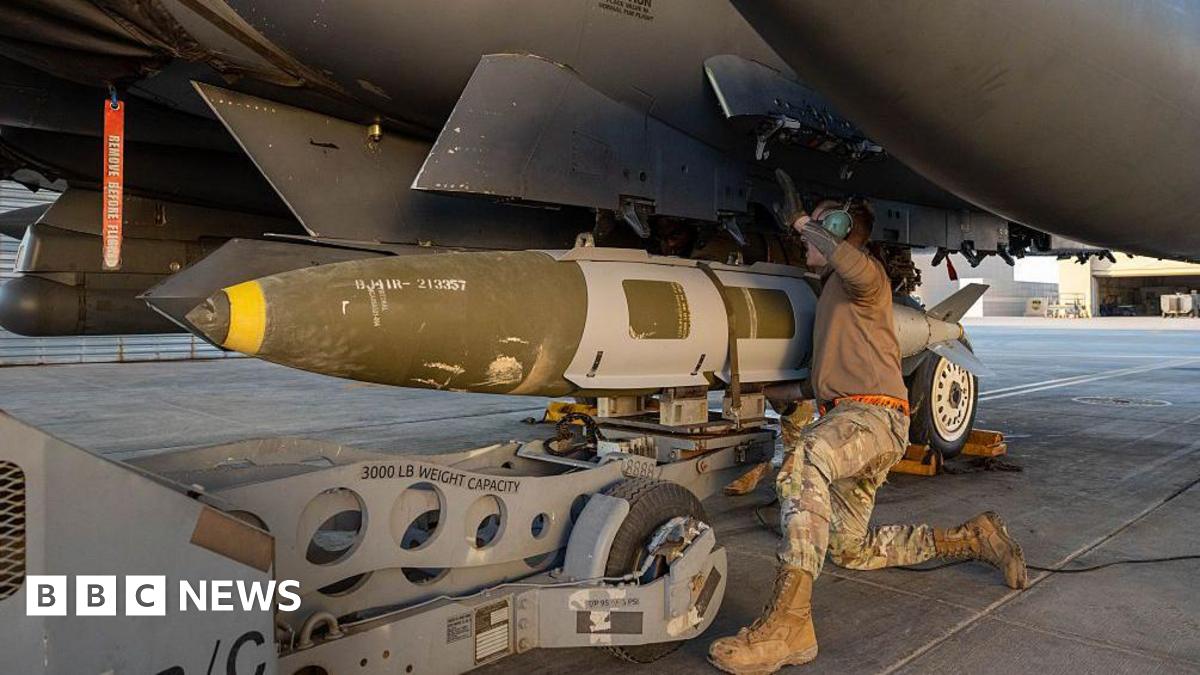 A handout from the US military shows a troop loading a missile for an attack in Syria last month