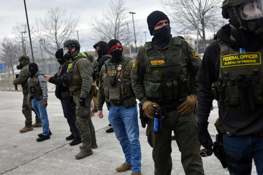 Federal law enforcement agents confront protesters during a demonstration outside the Bishop Whipple Federal Building in Minneapolis, Minnesota, on Thursday.