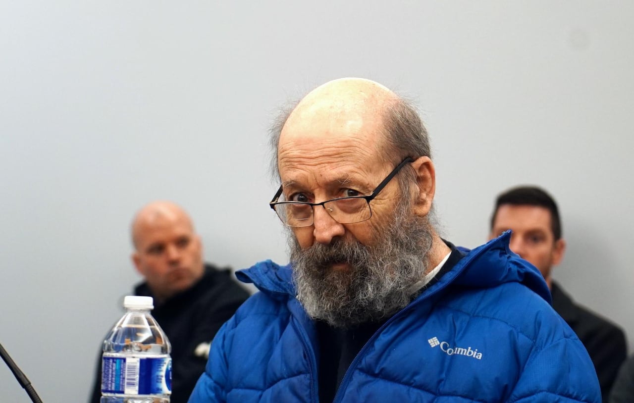 An older man with a thick grey beard and glasses.