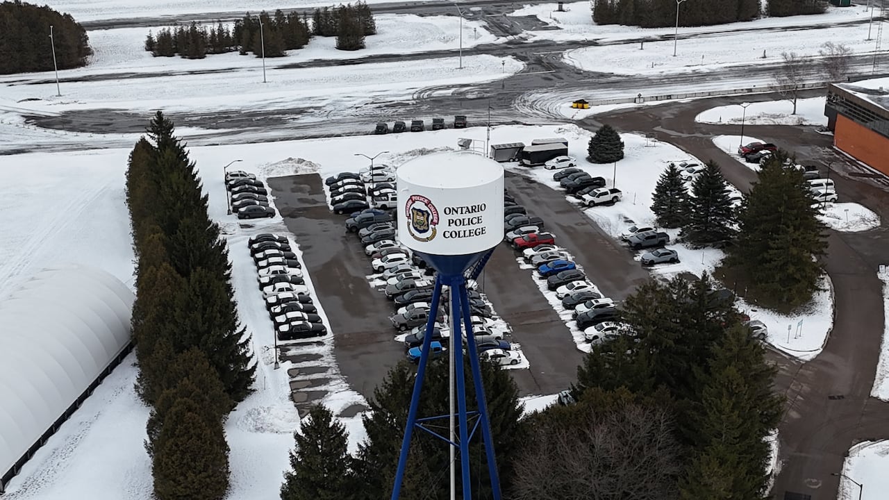 Drone image shows an Ontario Police College sign above a parking lot. 