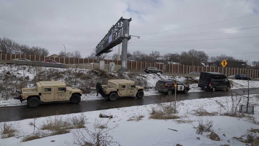 Minnesota Army National Guard soldiers post up in vehicles along a freeway ramp ahead of anticipated protests on Jan. 17, in Minneapolis. 