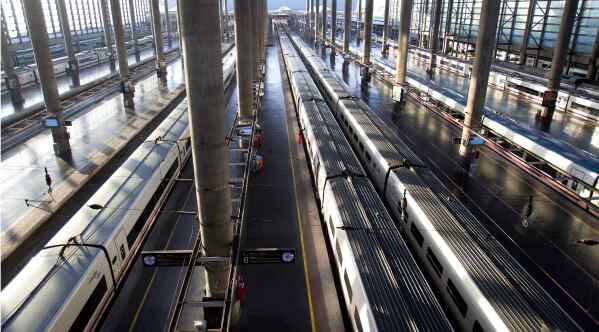 A worker cleans the windows of a high speed train at Atocha station in Madrid, March 29, 2012. (AP Photo/Paul White, File)