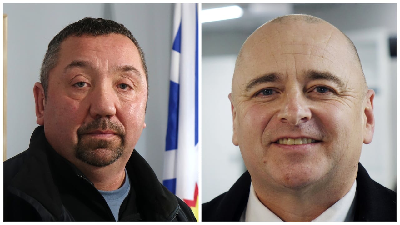 Two men stand for a portrait.