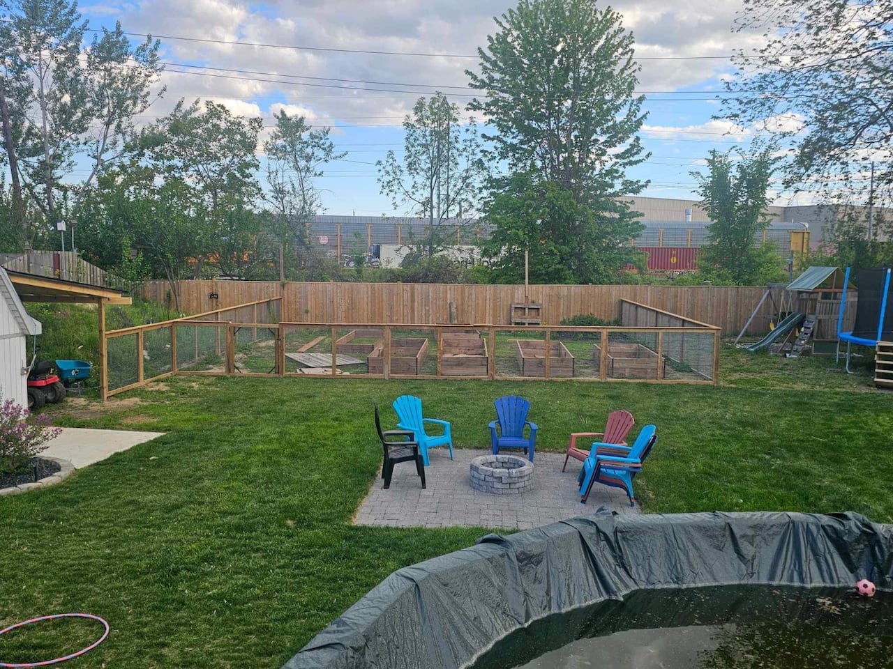 A backyard with chairs and pool