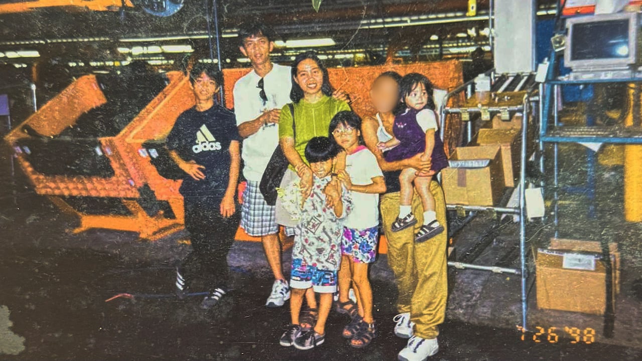 A picture of several members of the Jacildo family standing inside the Brampton Assembly Plant in 1998.