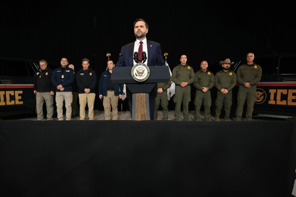 ICE vehicles sit in the background as federal immigration agents listen to US Vice President JD Vance speak at an industrial shipping facility on the administration's economic agenda and impacts on the Midwest in Toledo, Ohio, on Thursday, Jan. 22, 2026. (Jim Watson/Pool Photo via AP)