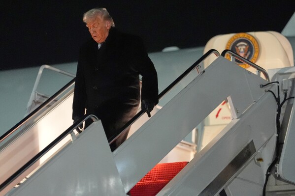 President Donald Trump arrives at Joint Base Andrews, Md., after attending the World Economic Forum in Davos, Thursday, Jan. 22, 2026. (AP Photo/Evan Vucci)