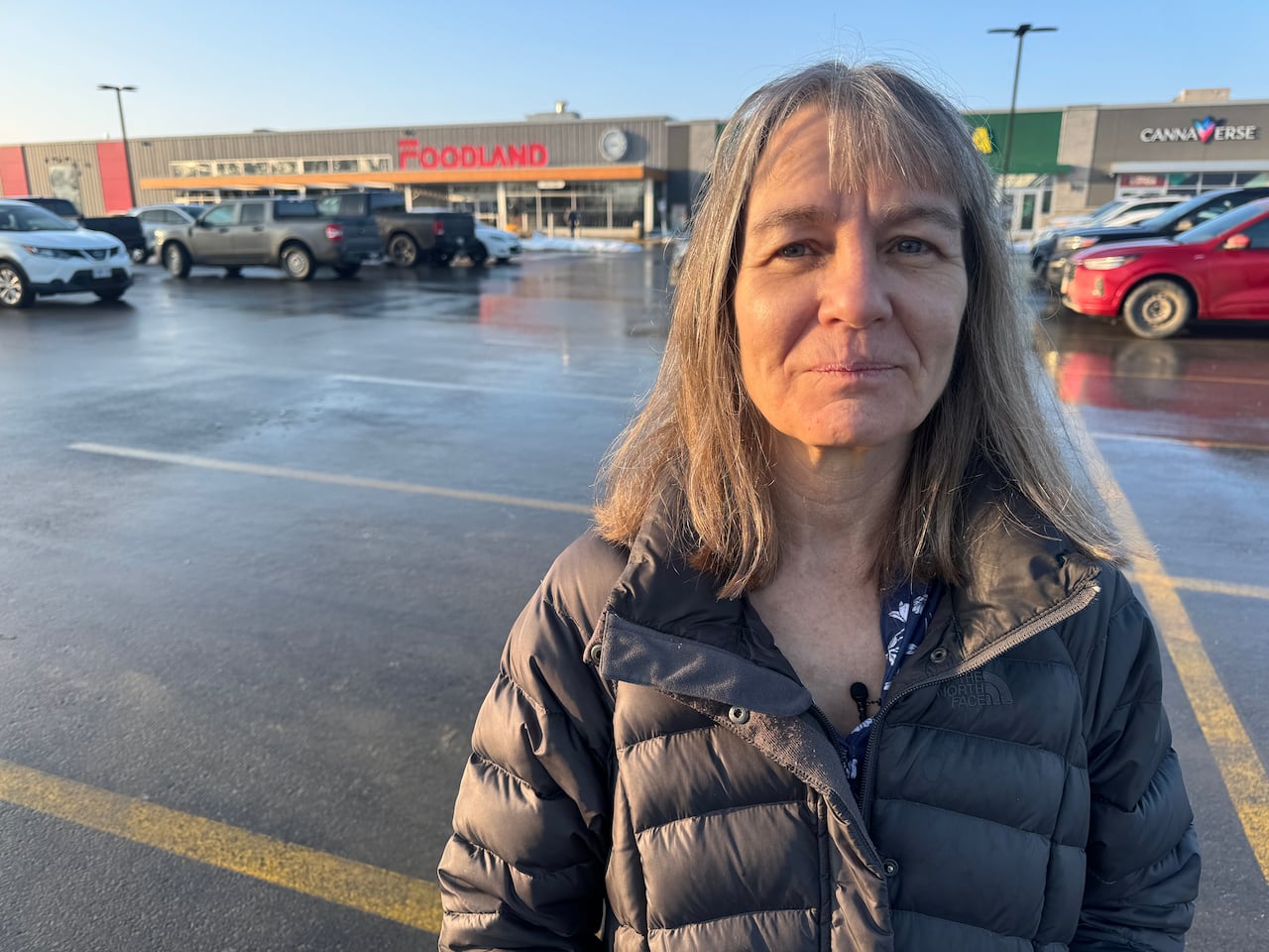 An image of Teresa Petrie standing in front of a grocery store.