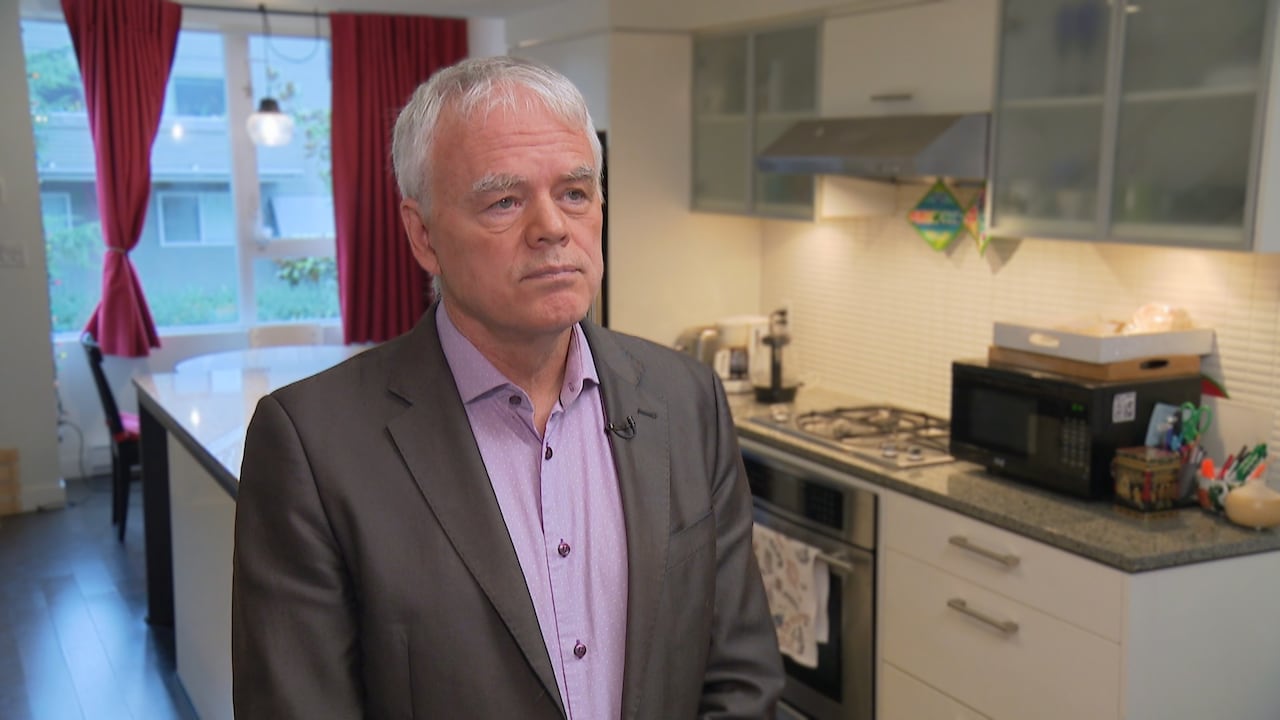 Economist Jim Stanford is seated in a kitchen for an interview.
