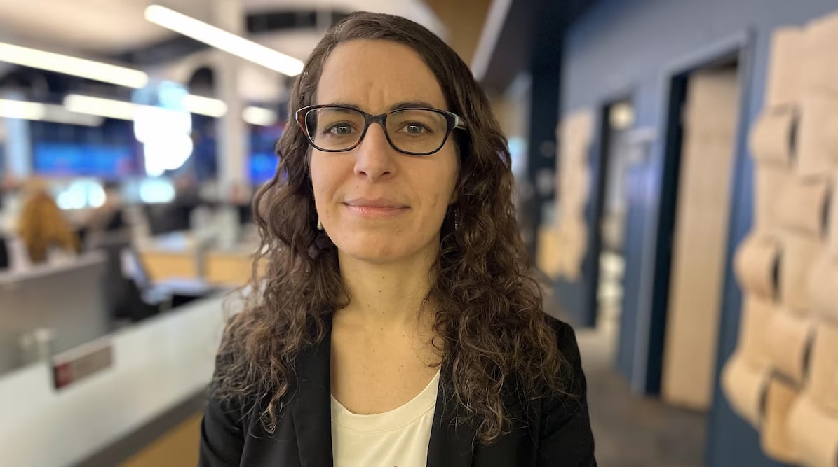 A woman poses for a photo