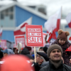 People wave Greenlandic flags as they take part in a demonstration that gathered almost a third of the city population to protest against the US President's plans to take Greenland, on January 17, 2026 in Nuuk, Greenland. 