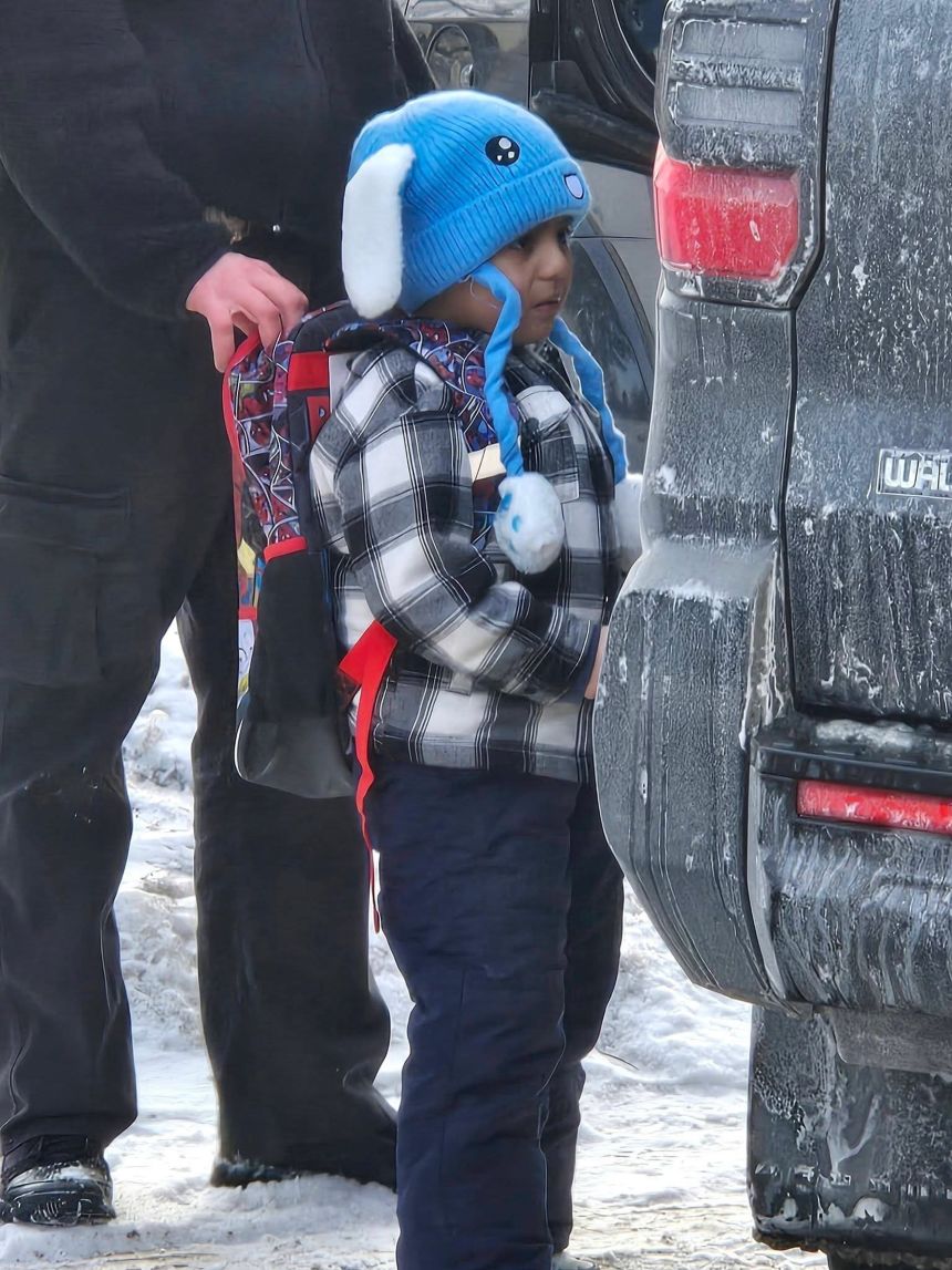 Federal immigration agents walk 5-year-old Liam Conejo Ramos to a vehicle in front of his Minneapolis home on Tuesday.