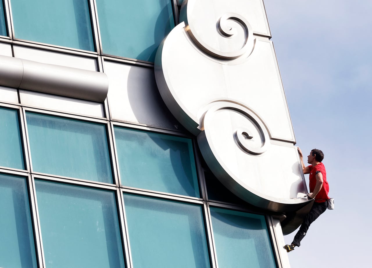 man climbing building