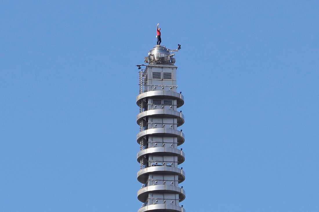 Rock climber Alex Honnold, of the U.S., raises his fist as he climbs on top of the Taipei 101 skyscraper in Taipei, Taiwan, Sunday, Jan. 25, 2026.