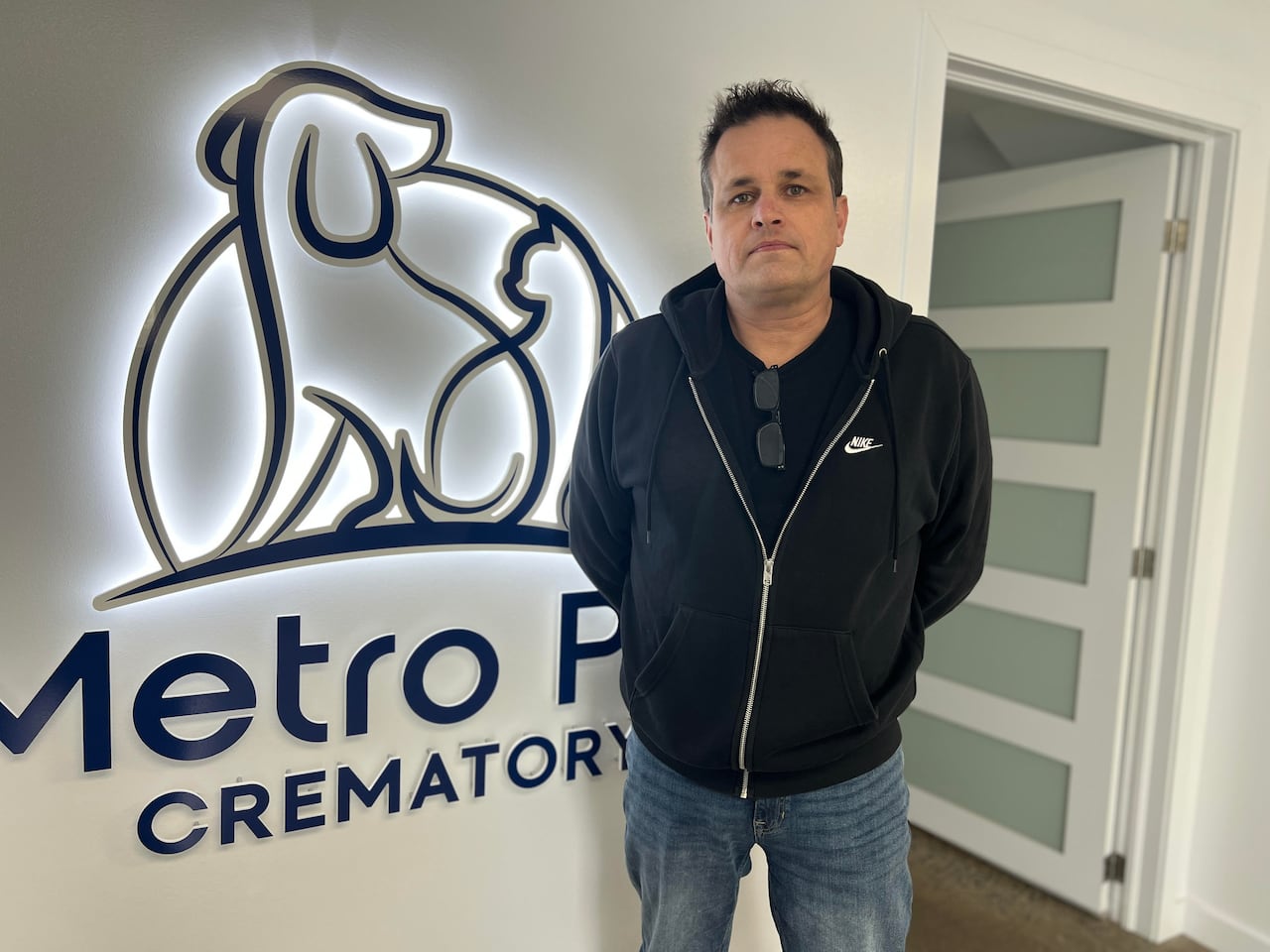 Man in front of business sign