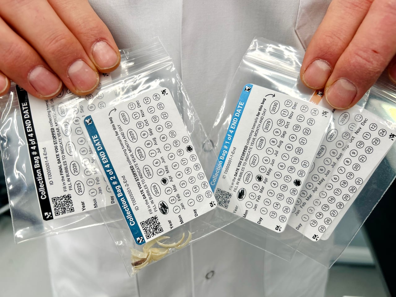 Dustin Pearson, the University of Calgary-based research operations manager for the Evict Radon study, holding bags of toenail samples.