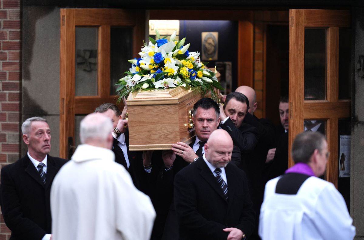 The casket is carried from the church by Kenny Logan and others following the funeral service for Terry Yorath 