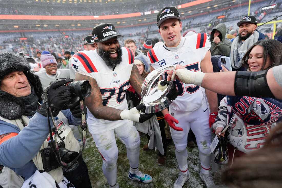 New England Patriots offensive tackle Morgan Moses (76) and tight end Hunter Henry celebrate after the AFC Championship NFL football game against the Denver Broncos, Sunday, Jan. 25, 2026, in Denver.