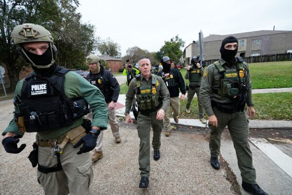 U.S. Customs and Border Protection Commander Gregory Bovino walks with border patrol agents through a neighborhood during an immigration crackdown, in Kenner, La., Dec. 5, 2025. (AP Photo/Gerald Herbert, File)