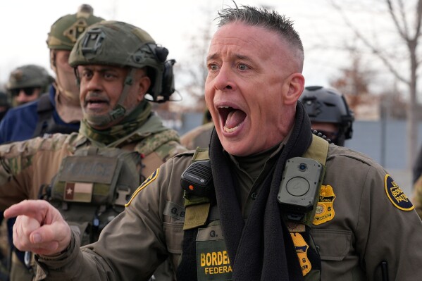 U.S. Customs and Border Protection Commander Gregory Bovino shouts at protesters, Sunday, Jan. 11, 2026, in Minneapolis. (AP Photo/Jen Golbeck)