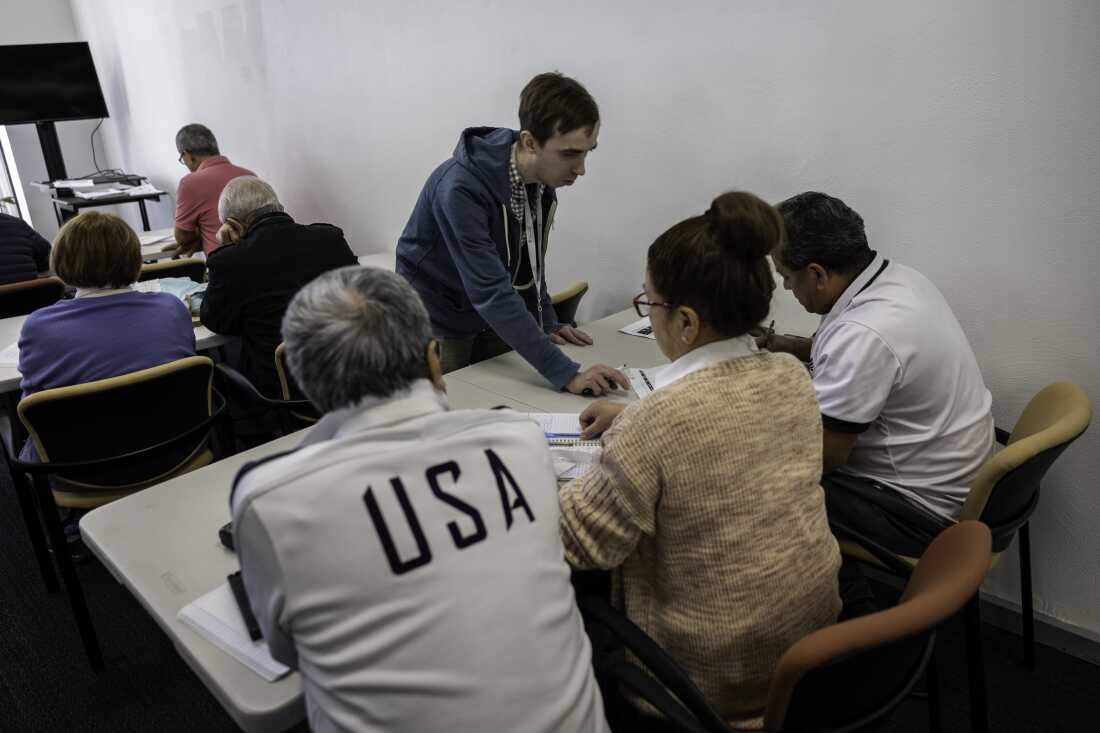 Immigrants study for a U.S. citizenship exam in Connecticut. The Census Bureau says net immigration dropped sharply in the 12 months ending last June, causing a sharp slowdown in overall population growth.