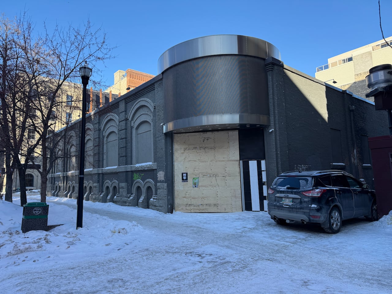 A boarded-up one-storey building.