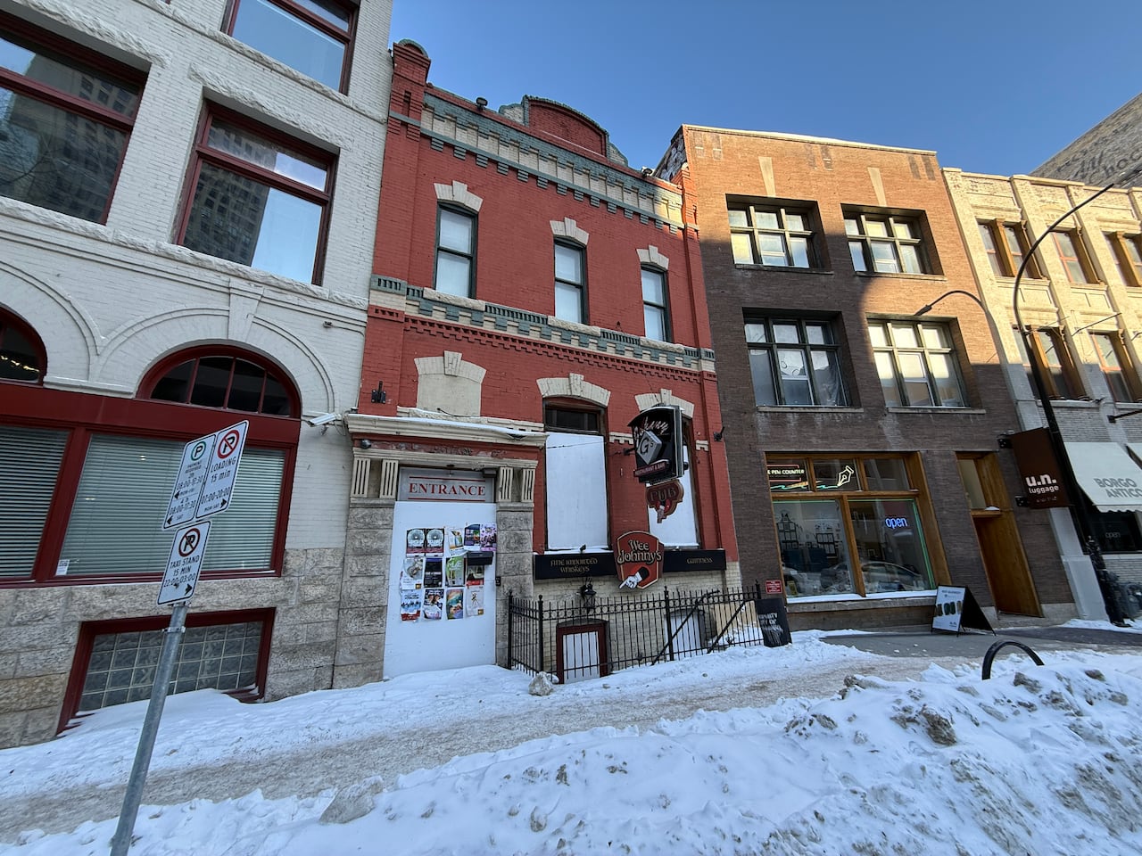 A boarded up red brick building.