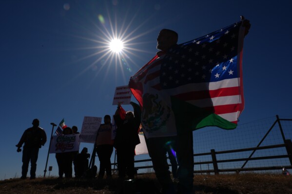 Protesters gather outside the South Texas Family Residential Center detention facility where Liam Ramos and his father are being detained in Dilley, Texas, Wednesday, Jan. 28, 2026. (AP Photo/Eric Gay)