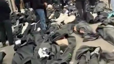 Bodies line the streets outside a morgue in Tehran as protests continue – video