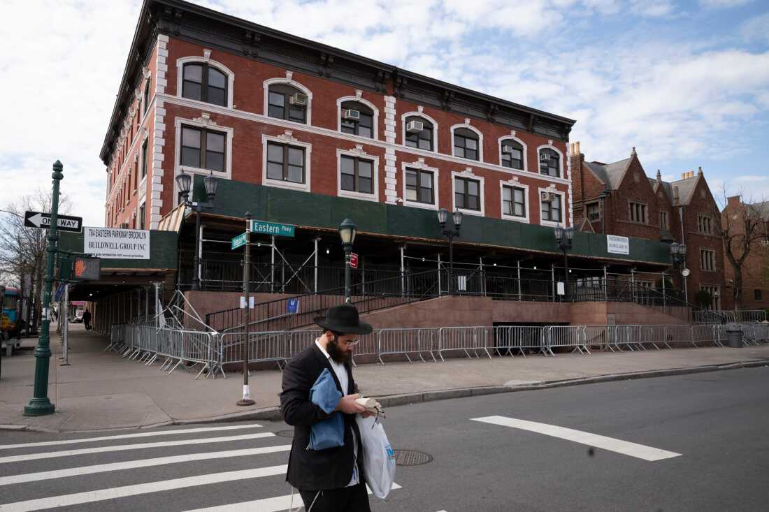 A man passes the Chabad-Lubavitch World Headquarters in the Crown Heights neighborhood of Brooklyn, April 7, 2020 in New York.