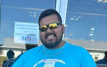 Man standing next to child