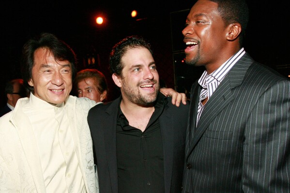 Jackie Chan, from left, Brett Ratner and Chris Tucker appear at the "Rush Hour 3" premiere after party in Los Angeles on July 30, 2007. (AP Photo/Matt Sayles, File)