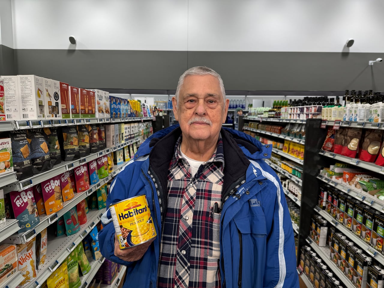  Shopper Bob Bastien holds up a can of Habitant French-Canadian Pea Soup. 