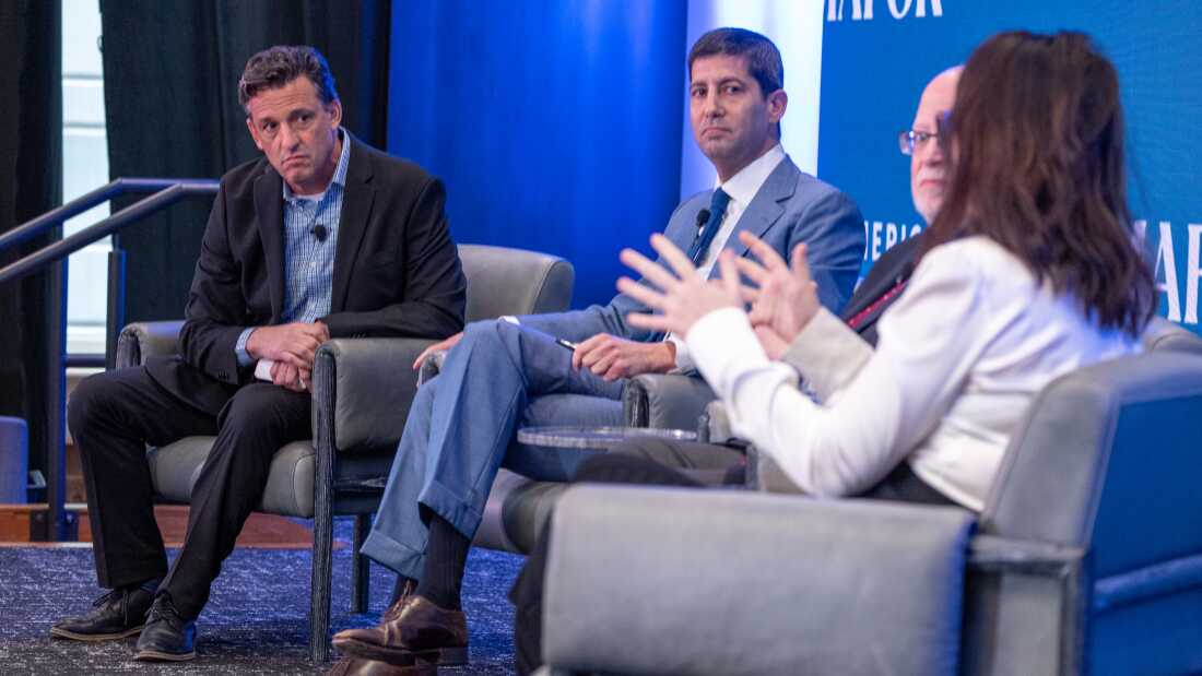 Kevin Warsh (center) is President Trump's pick to lead the Federal Reserve. Warsh is a former Fed governor who has echoed the president's call for lower interest rates.