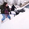 Emma Teske shovels out her car following a winter storm that dumped more than a foot and a half of snow across the region on Tuesday in Haverhill, Mass.