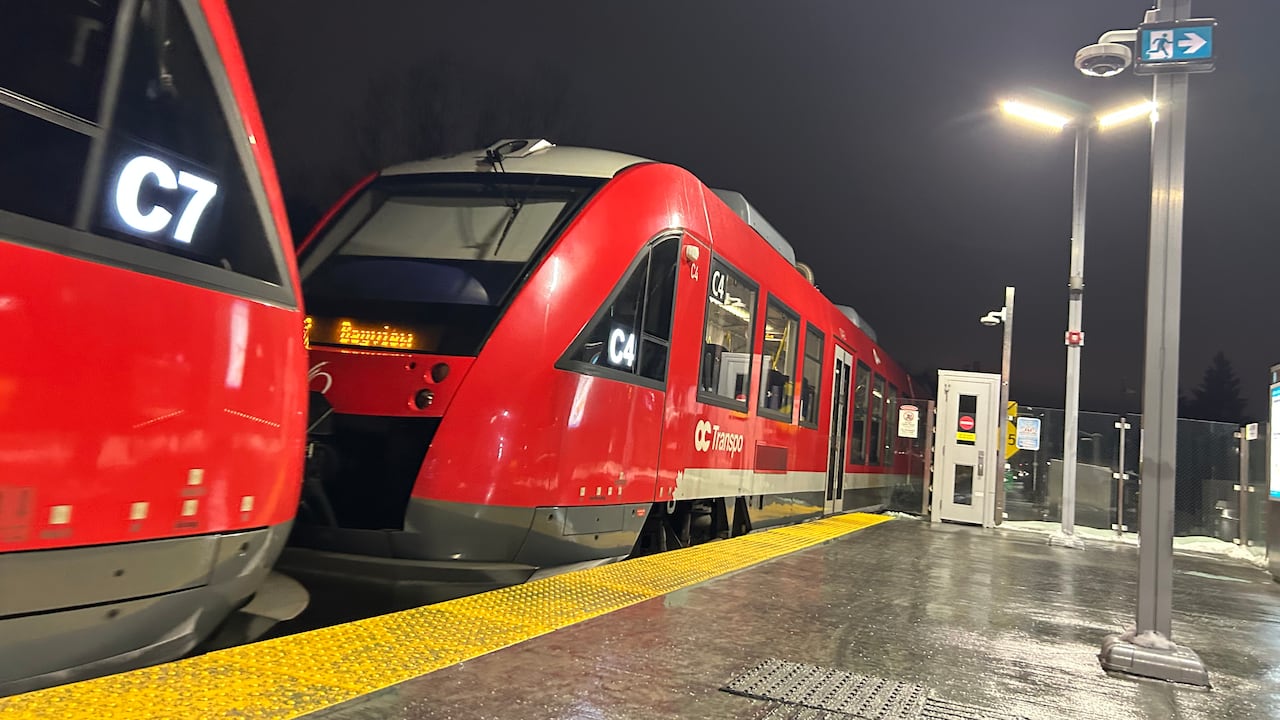 A public transit train at a station early on a winter morning.