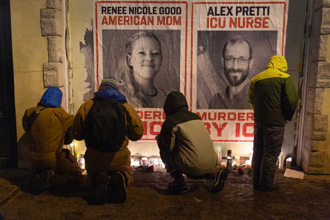 People attend a candlelight vigil this week organized by health care workers at the site where Alex Pretti was killed in Minneapolis.