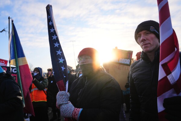 People gather for a protest outside the Bishop Henry Whipple Federal Building, Friday, Jan. 30, 2026, in Minneapolis. (AP Photo/Adam Gray)