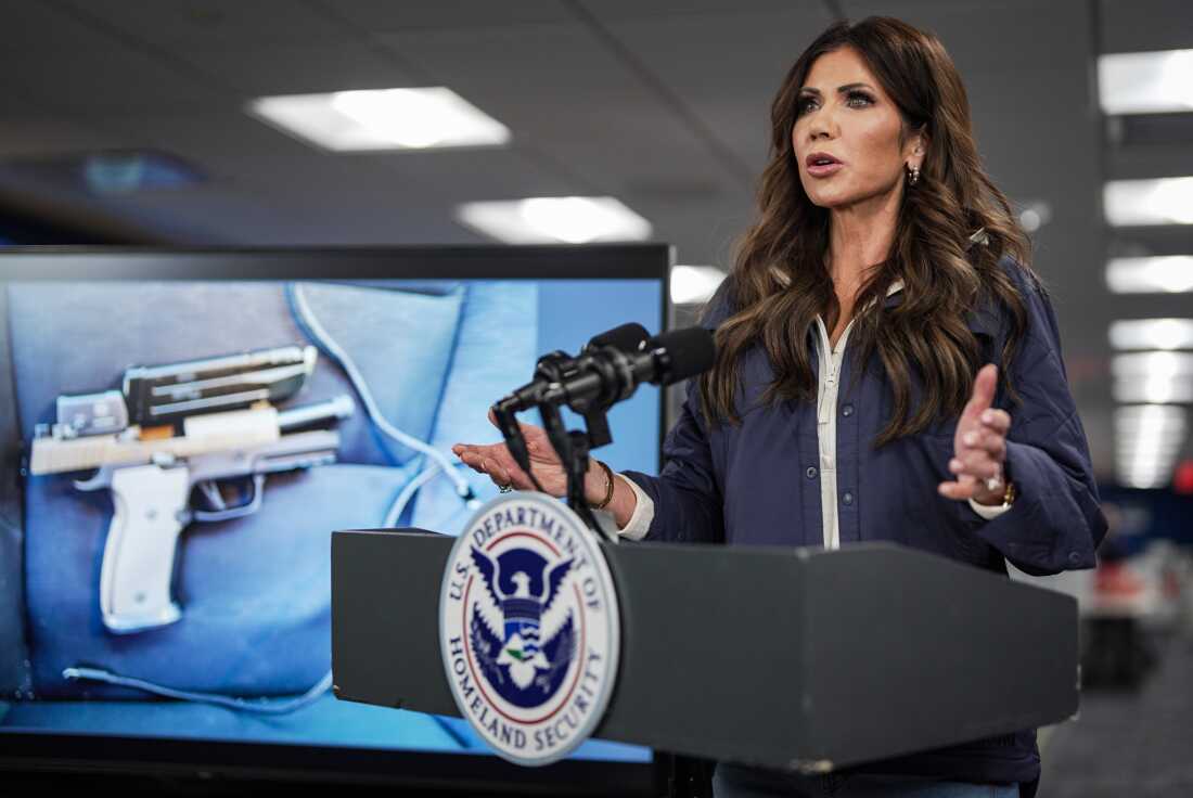 A photograph of the pistol recovered by immigration agents after a shooting in Minneapolis is shown on a screen behind U.S. Secretary of Homeland Security Kristi Noem as she speaks during a news conference in Washington, D.C., on Jan. 24. Federal immigration agents shot and killed Alex Pretti that day during operations in Minneapolis.