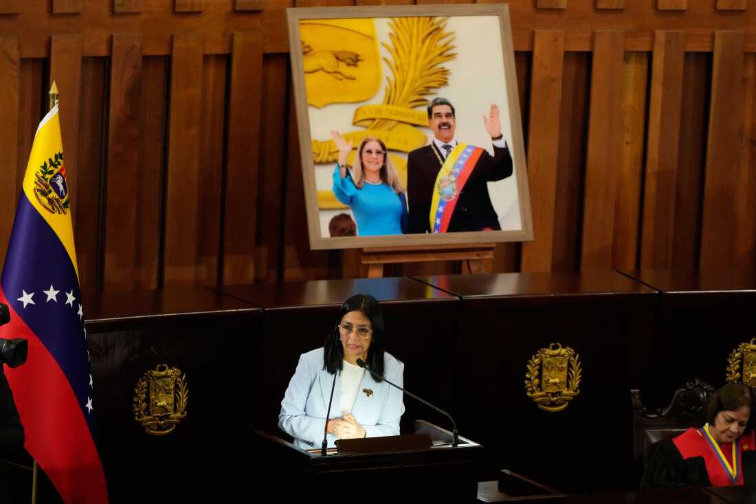 Venezuelan acting President Delcy Rodriguez speaks under a framed image of former President Nicolas Maduro and his wife Cilia Flores, during a ceremony marking the opening of the new judicial year at the Supreme Tribunal of Justice in Caracas, Venezuela, Friday, Jan. 30, 2026.