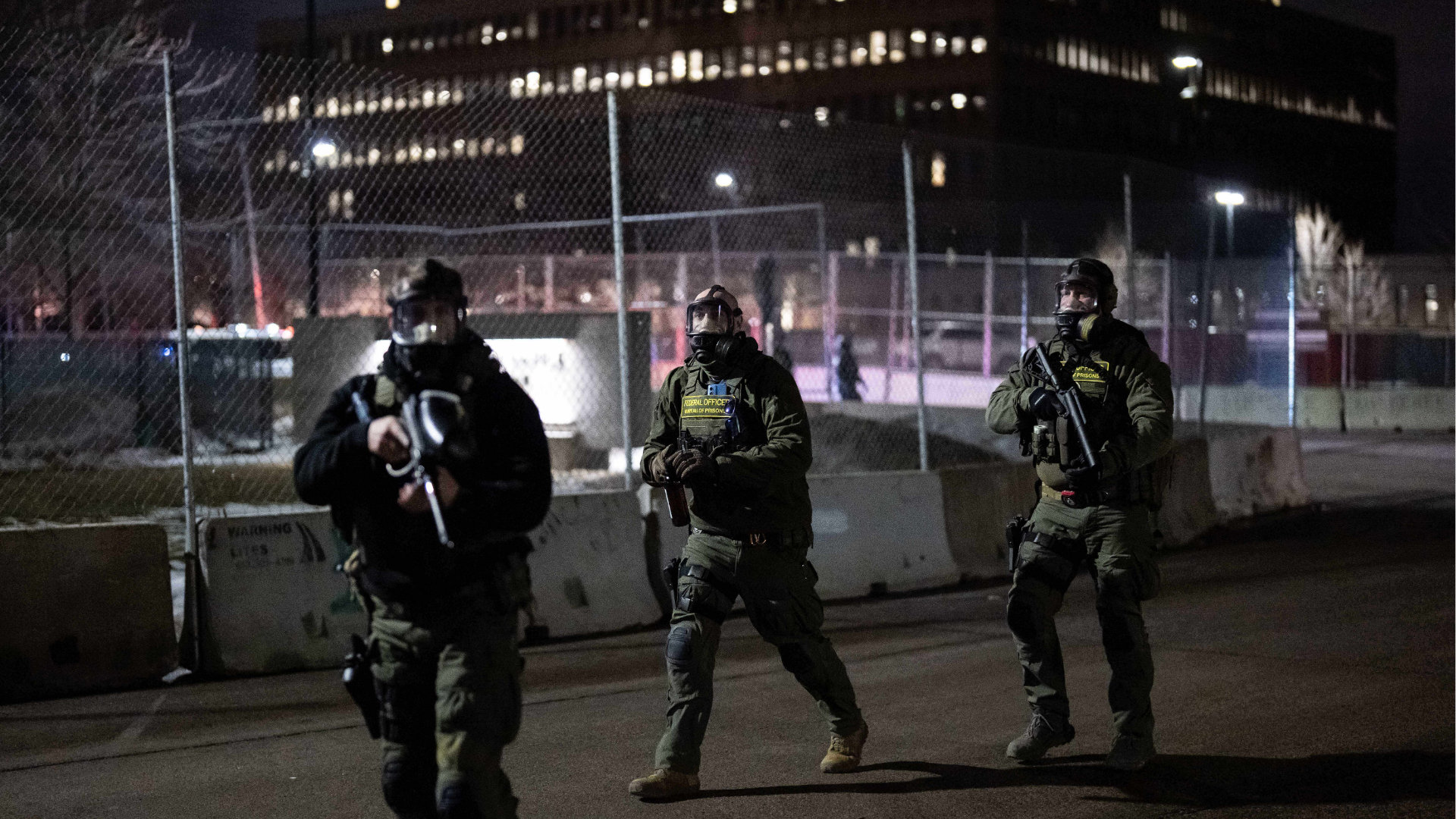 Federal officers rush to detain a person outside Bishop Henry Whipple Federal Building, Tuesday, Jan. 13, 2026, in Minneapolis.