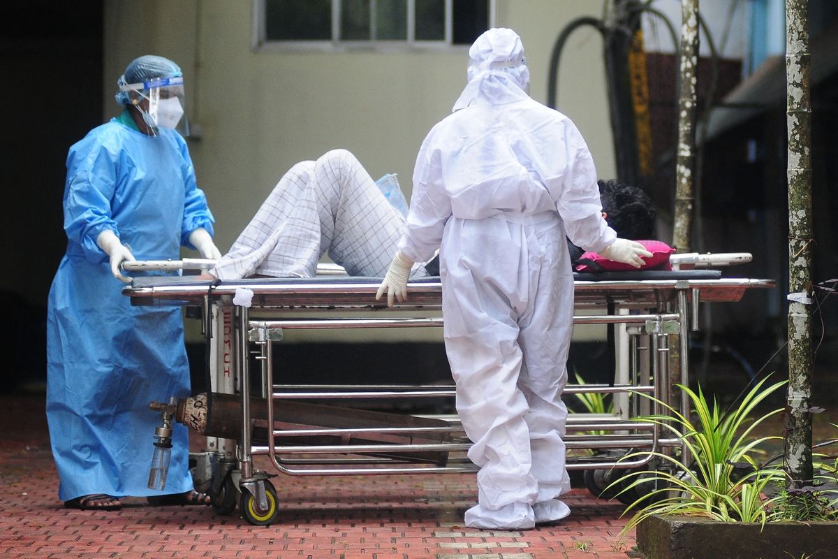 A photo of health workers shifting a man with Nipah