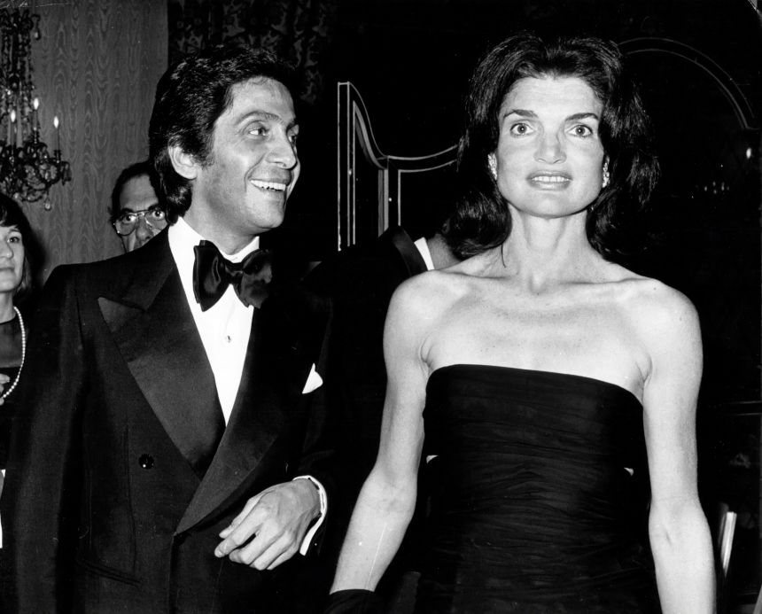 Valentino and former first lady Jacqueline Kennedy Onassis at a Valentino fashion show benefit for the Special Olympics in 1976. (Photo by PL Gould/IMAGES/Getty Images)