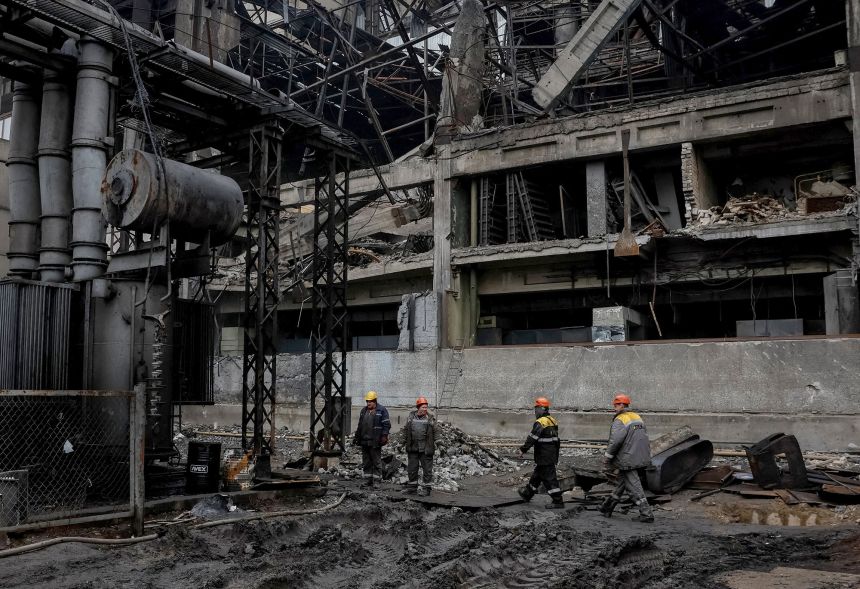 Employees work at a thermal power plant damaged by a Russian missile strike in an undisclosed location of Ukraine, on November 13, 2025.
