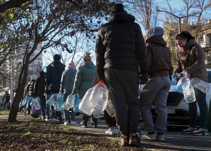 Residents stand in line to fill up bottles with drinking water after Russian attacks on critical infrastructure in Odesa, Ukraine, on December 13, 2025.