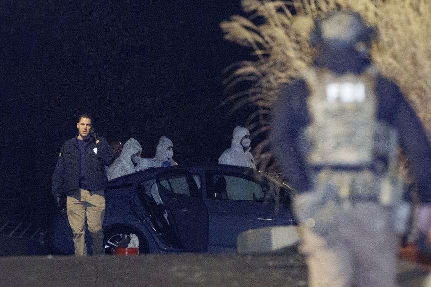 Investigators look December 18 at a grey Nissan at a storage facility in New Hampshire, where the Brown University suspect took his own life.